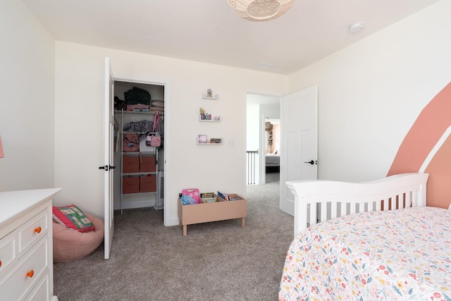 bedroom featuring light colored carpet, a walk in closet, and a closet