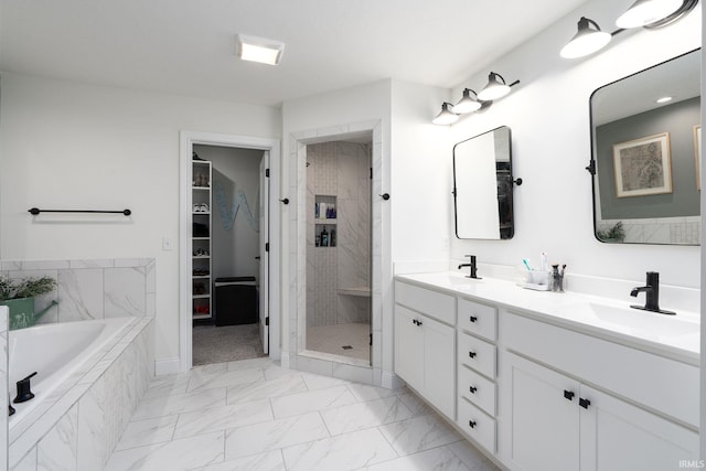 bathroom with vanity and shower with separate bathtub