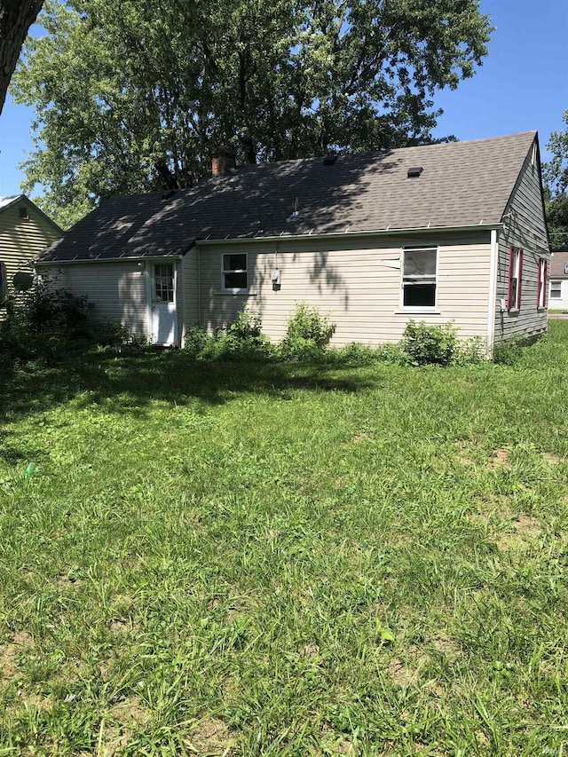 back of house with a yard