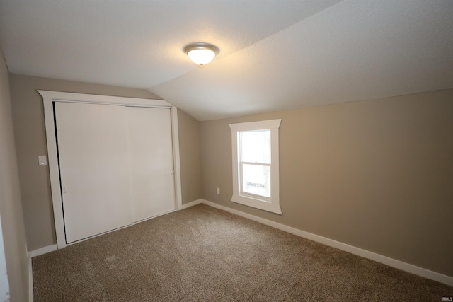 additional living space with lofted ceiling and carpet flooring