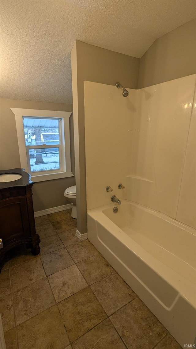 full bathroom with shower / bathtub combination, vanity, toilet, and a textured ceiling