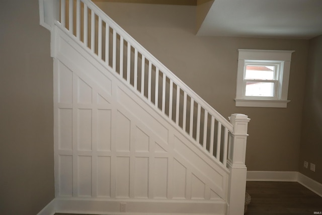 stairway with hardwood / wood-style flooring