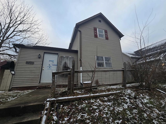 view of snow covered rear of property