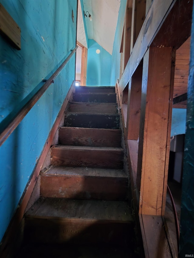 stairs featuring vaulted ceiling