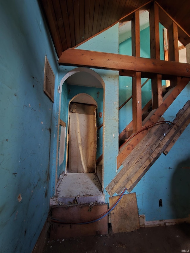 hall featuring lofted ceiling