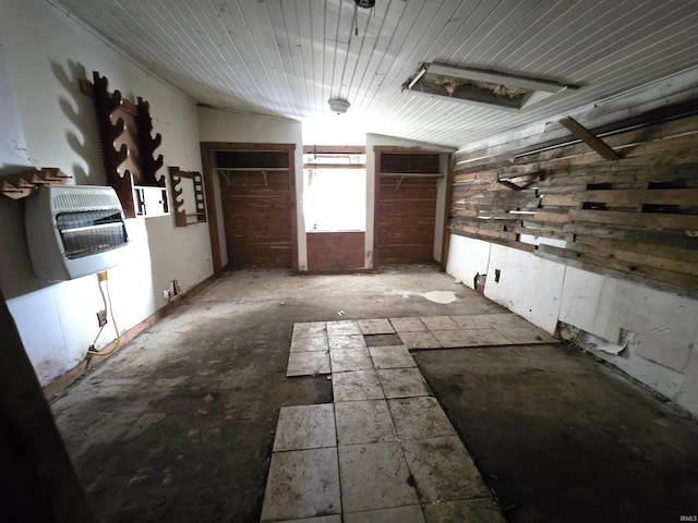 interior space featuring heating unit and vaulted ceiling