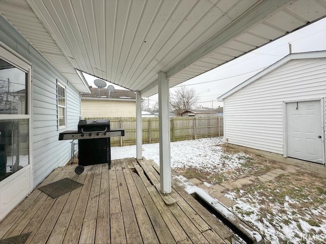 snow covered deck featuring a grill