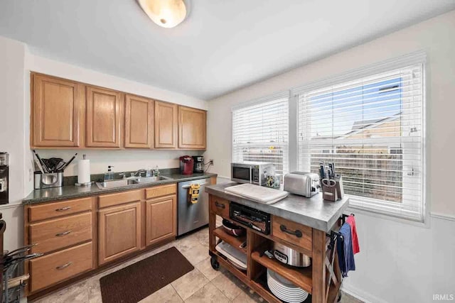 kitchen with light tile patterned flooring, stainless steel appliances, and sink