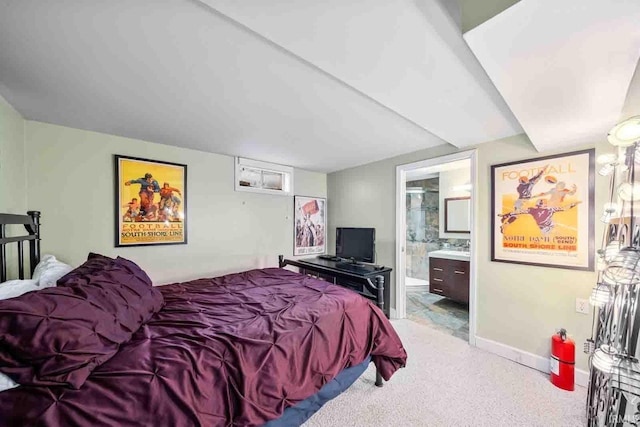 carpeted bedroom featuring connected bathroom