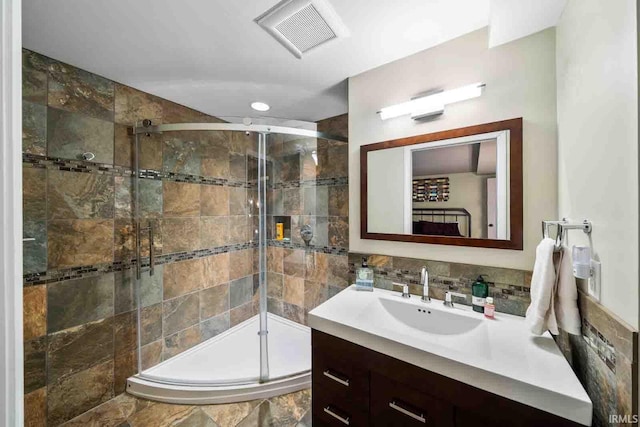 bathroom with a shower with door and vanity