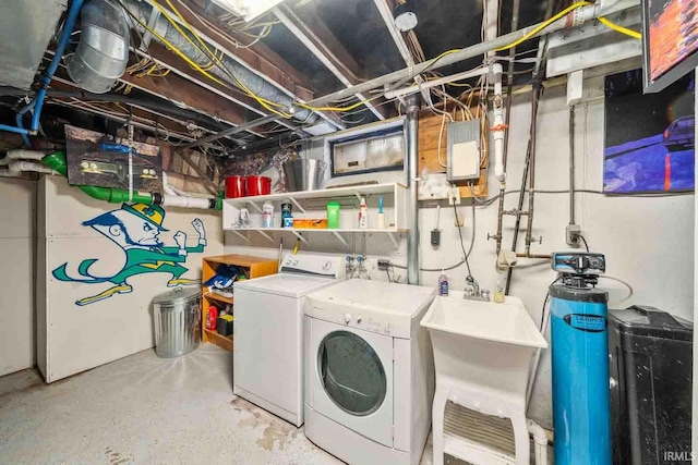 laundry area with independent washer and dryer and sink