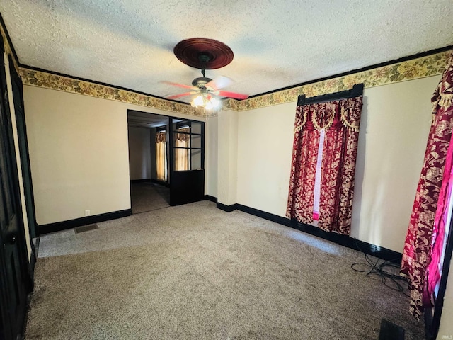 unfurnished room with a textured ceiling and ceiling fan