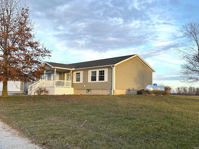 exterior space featuring covered porch and a front lawn