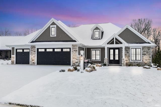 view of front of property featuring french doors and a garage