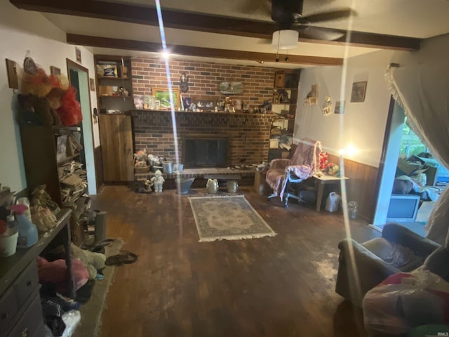 living room featuring a brick fireplace, hardwood / wood-style flooring, ceiling fan, built in features, and beam ceiling