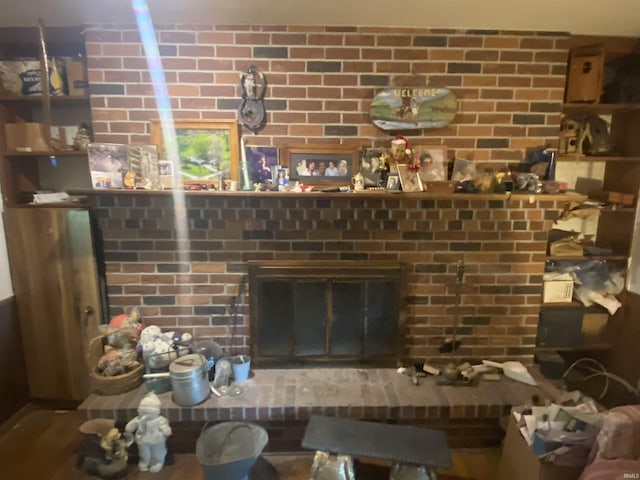 interior details featuring a brick fireplace