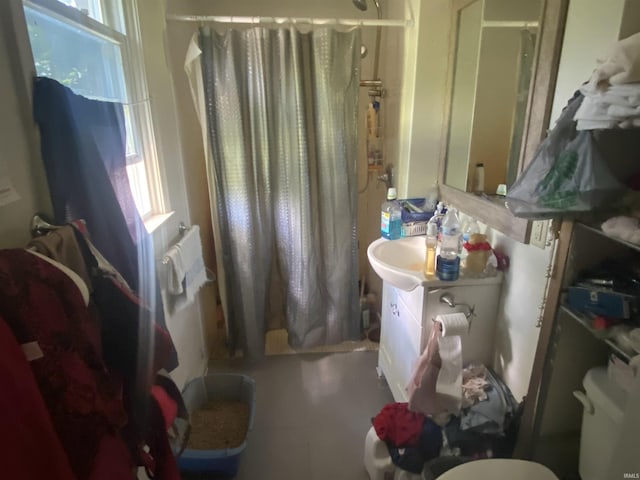 bathroom featuring vanity, toilet, and walk in shower