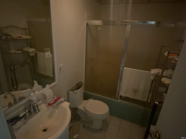 full bathroom with tile patterned flooring, toilet, combined bath / shower with glass door, and sink