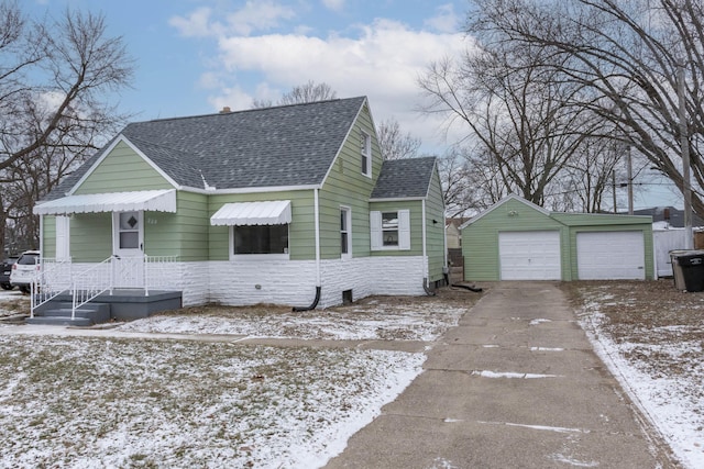 view of front of property featuring a garage and an outbuilding