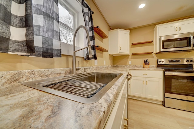 kitchen featuring sink, white cabinetry, and stainless steel appliances