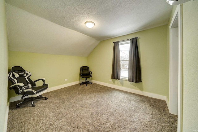 unfurnished room featuring lofted ceiling, a textured ceiling, and carpet floors