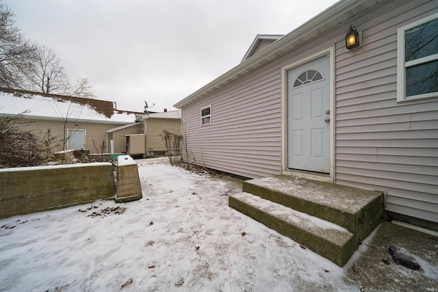 view of snow covered property entrance