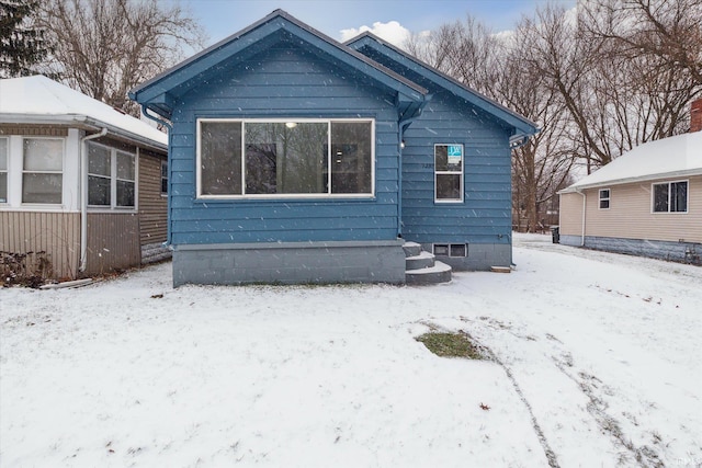 view of snow covered rear of property