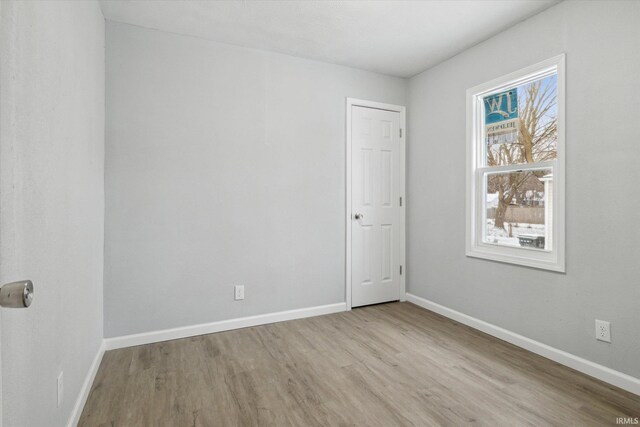 spare room with a healthy amount of sunlight and light hardwood / wood-style flooring