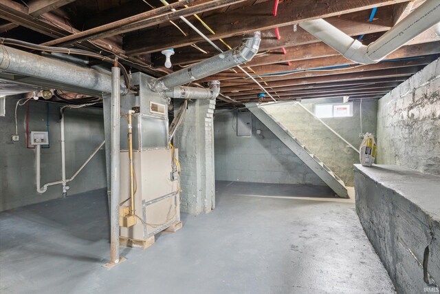 basement with electric panel and heating unit