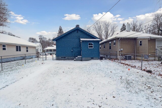 view of snow covered back of property