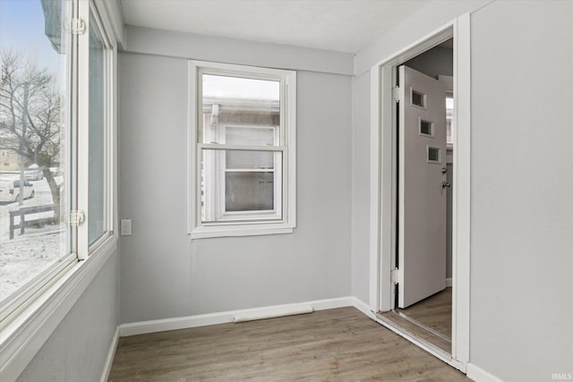 unfurnished room with hardwood / wood-style flooring