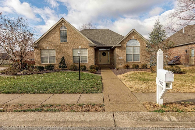 front facade with a front yard