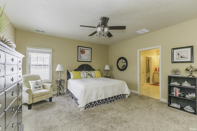 carpeted bedroom featuring ceiling fan and ensuite bathroom