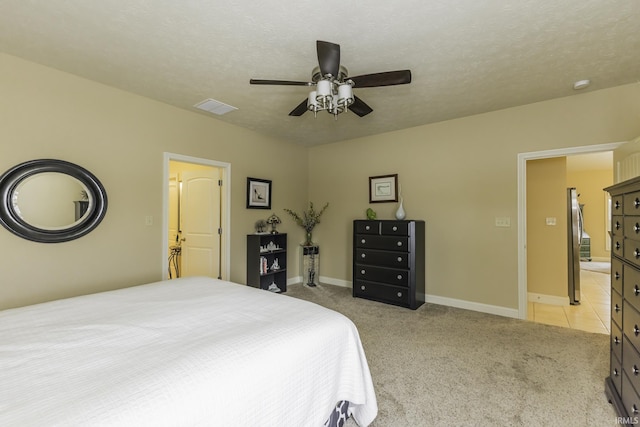 carpeted bedroom featuring a textured ceiling and ceiling fan