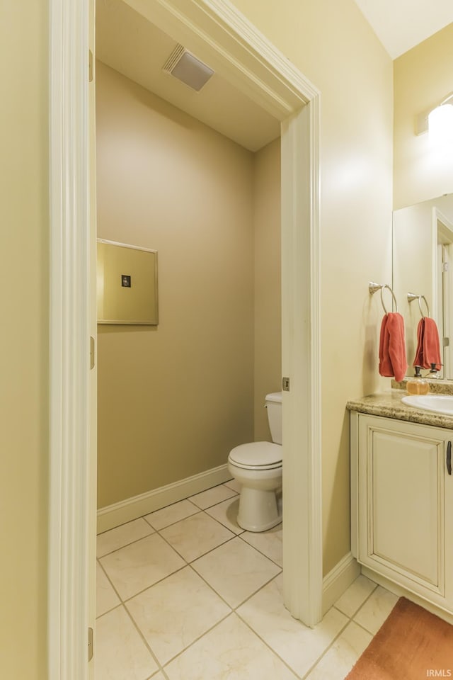 bathroom with tile patterned flooring, vanity, and toilet