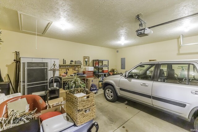 garage featuring electric panel and a garage door opener