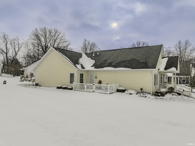 view of snow covered rear of property