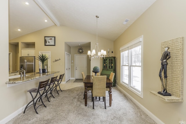 carpeted dining space featuring vaulted ceiling with beams and an inviting chandelier