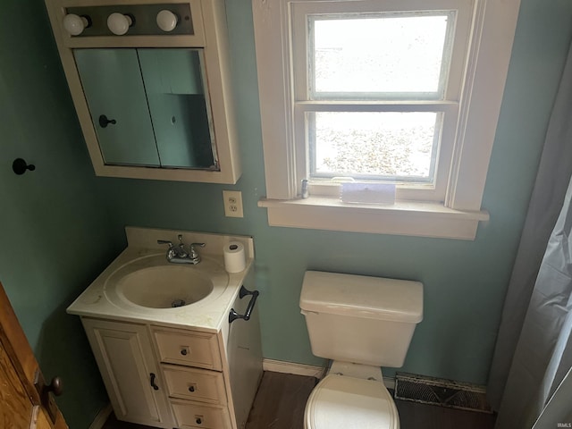 bathroom with hardwood / wood-style floors, vanity, and toilet