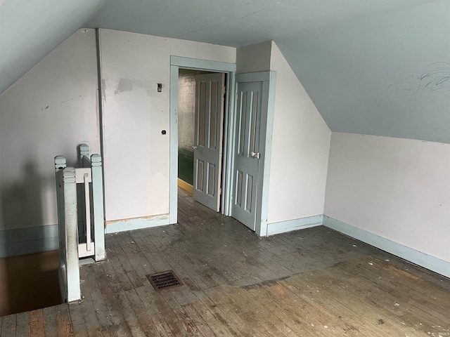 bonus room featuring dark hardwood / wood-style flooring and lofted ceiling