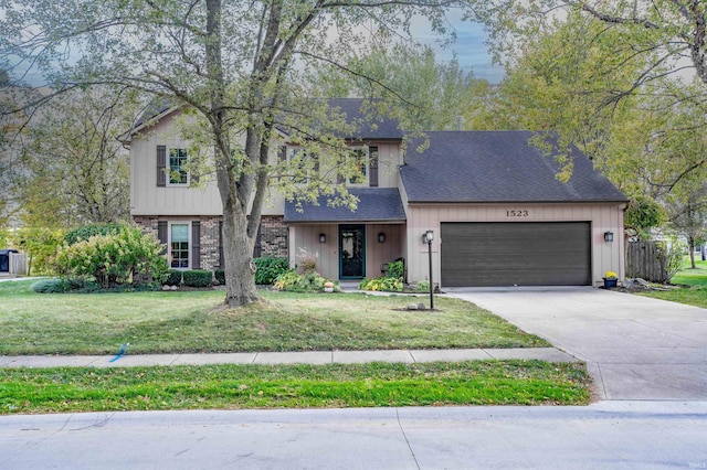 view of front of house featuring a front yard and a garage