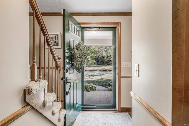 foyer featuring crown molding