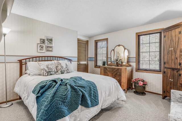 carpeted bedroom with a textured ceiling