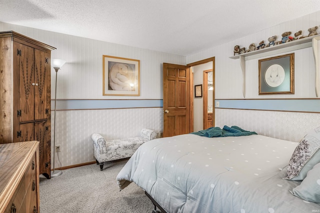 carpeted bedroom featuring a textured ceiling