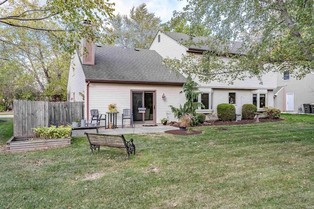 rear view of house featuring a lawn, a patio area, and central AC