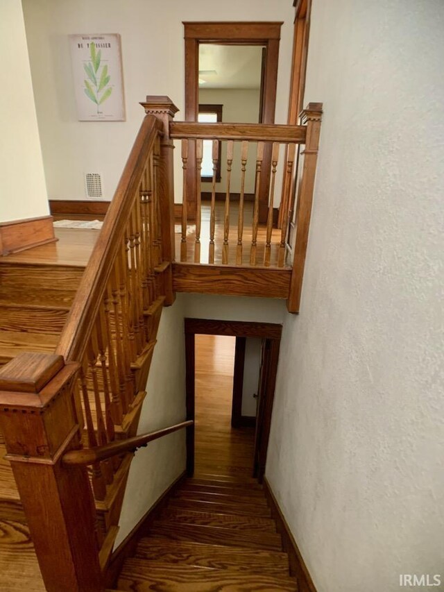 stairway featuring hardwood / wood-style flooring