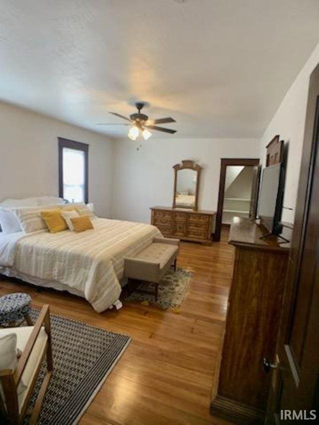 bedroom featuring ceiling fan and hardwood / wood-style floors