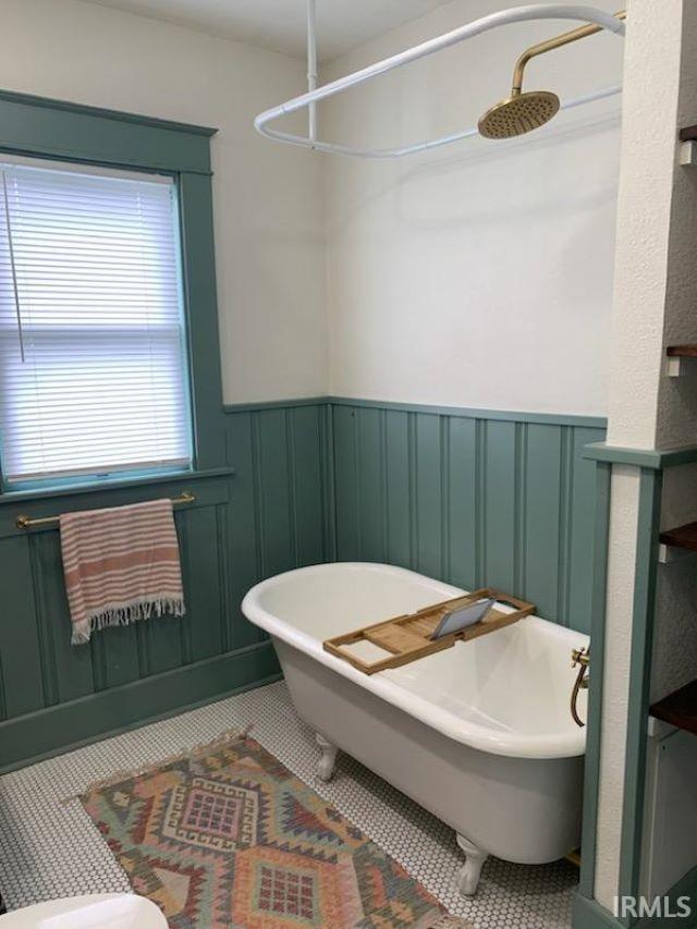 bathroom featuring tile patterned flooring and plus walk in shower