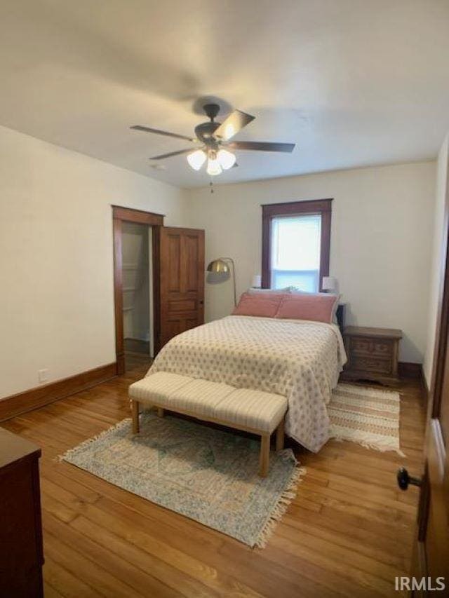 bedroom featuring hardwood / wood-style flooring and ceiling fan