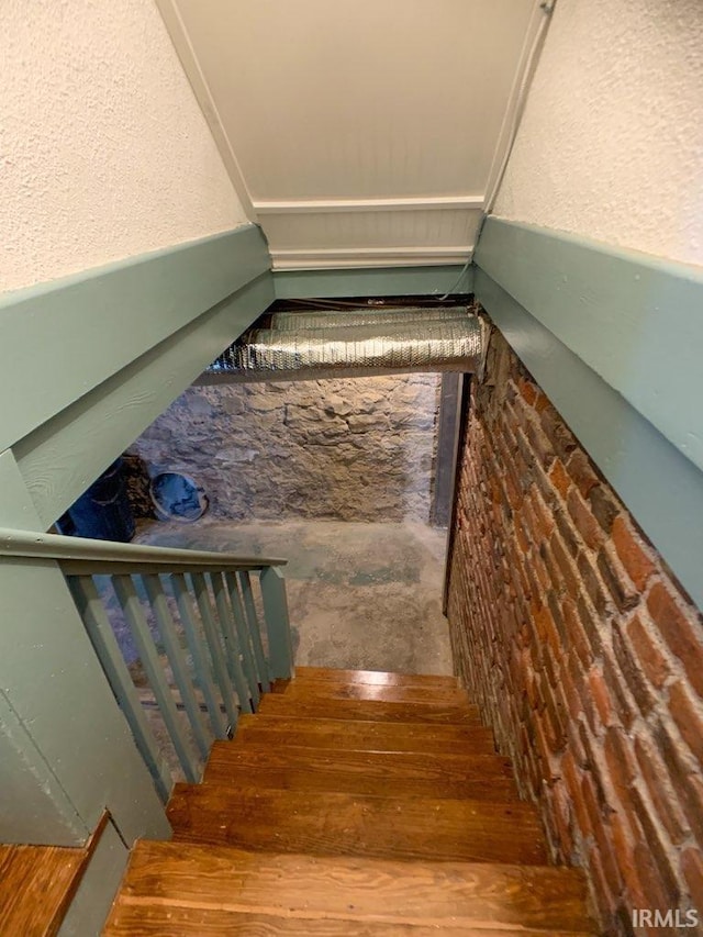 stairs featuring hardwood / wood-style floors